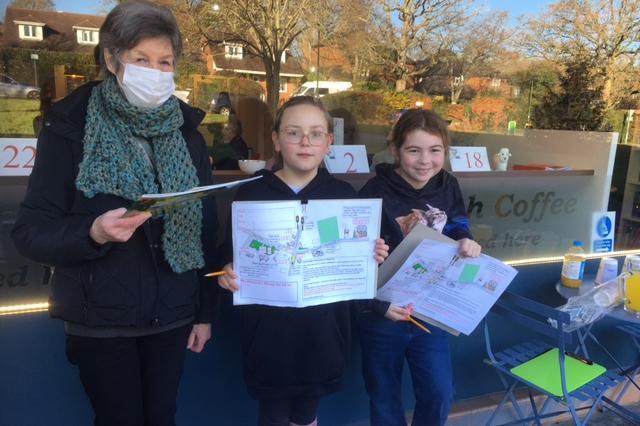 Pauline Colcutt giving out maps to Louisa Hamilton, 9, and  Annabelle Smalley, 11.