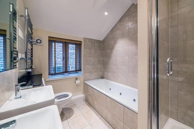 The bathroom with panel bath as well as shower cubicle