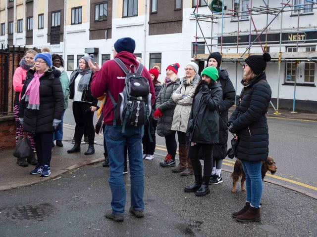 Founder of 'Northamptonshire Walks', Dave Askew, gives a tour of Northampton's shoe factory district to the fortnightly Women's Wellness Walks hosted by Saints Coffee and granola business owner, Salma Shah. Sunday, December 5 2021. Photo by Kirsty Edmonds.