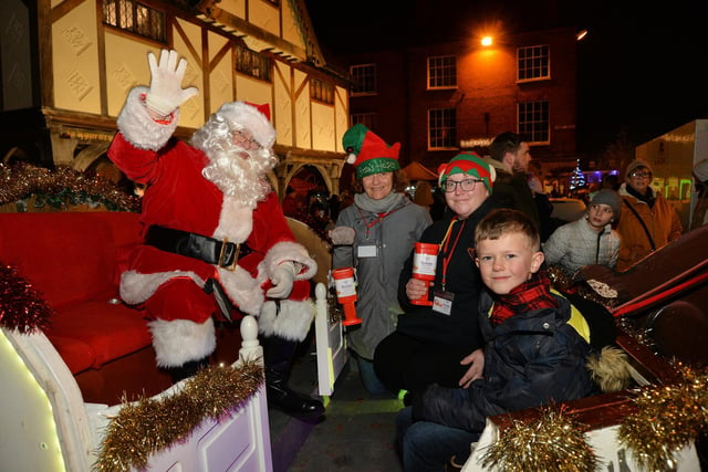 3rd Market Harborough Scouts Santa's sleigh with helpers Sam Gisborne and Sarah Ferns with visitor Olver Smith, 6.