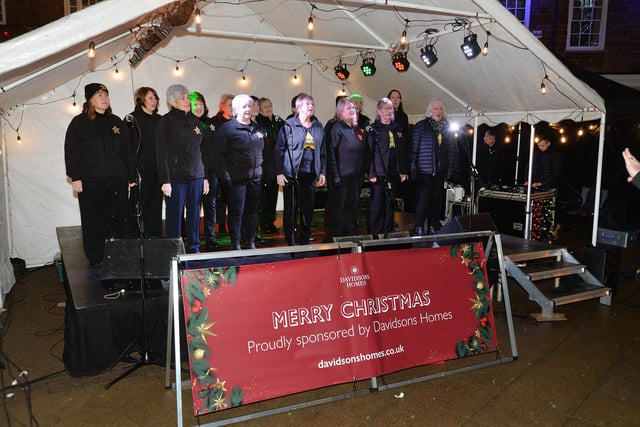 The Rock Choir perform on the Davidsons Homes stage on the Square during the Christmas Fair.