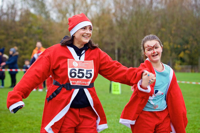 Two runners at the 5K Santa Fun Run to benefit Katharine House Hospice at Spiceball Park in Banbury on Sunday December 5 (Image from David Fawbert photography)