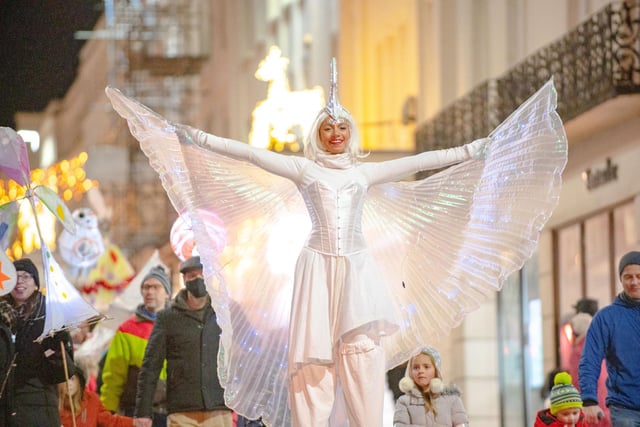 A shimmering stilt-walking angel from Flambé Circus Theatre leading the 2021 Leamington Lantern Parade