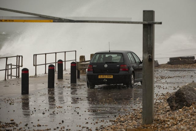 Selsey seasfront gets a lashing from storm 'Barra' as a car leaves the beach car park at Hilfield Road. By Chris Hatton SUS-210812-084422003
