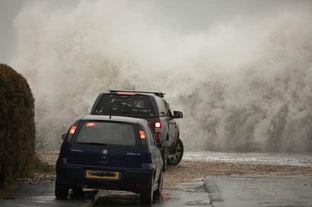 Selsey seasfront gets a lashing from storm 'Barra' as a car and van get up close to the force of nature. By Chris Hatton SUS-210812-084442003