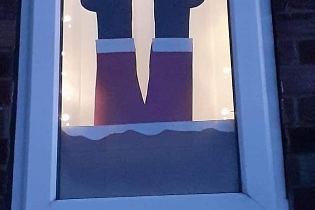 Window number 2 cleverly shows a Santa falling down the chimney.