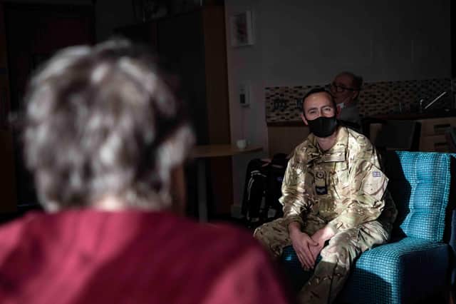 One of the residents in conversation with RAF Chef, Corporal James McInerney. Photo:  SAC Kimberley Waterson.