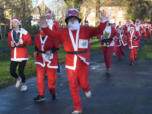 Participants in the annual Boston Santa Run hosted by Boston Community Runners.