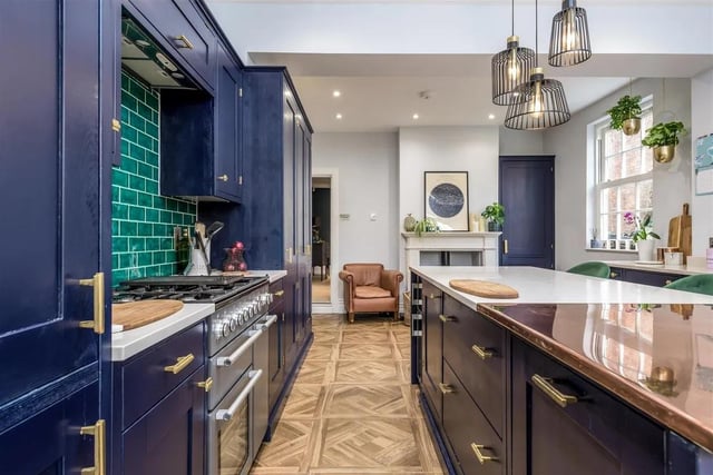 The kitchen comprises a range of hand-built painted units and there is space for a range cooker and varying integrated appliances which include a wine cooler. The kitchen also features a granite and copper-topped island