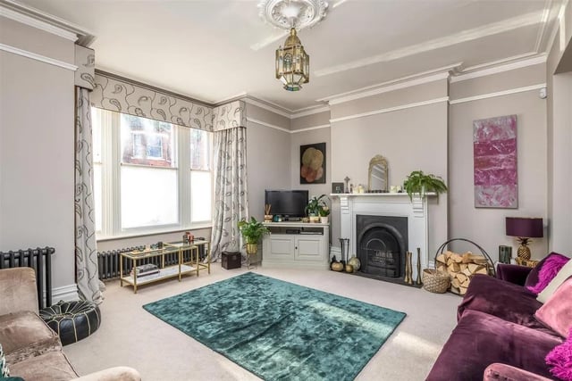 The former sitting and family rooms have now been combined and include many attractive features such as matching open fireplaces, a box bay window to the front and doors to the rear