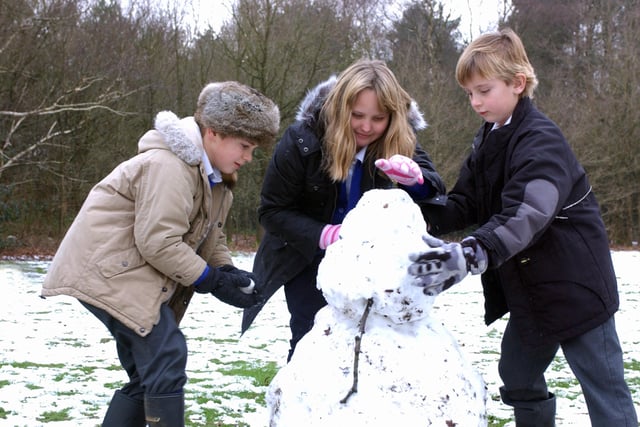 Stedham Primary School pupils Fred, eight, Tarya, nine, and Freddie, nine, having fun making a snowman in January 2007. Picture: Kate Shemilt