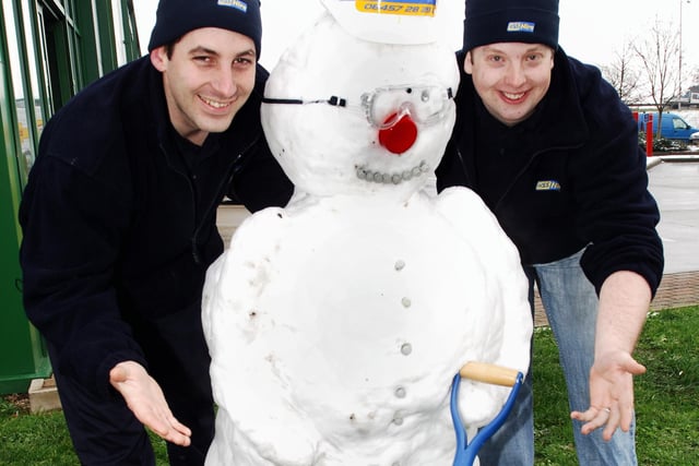 Darren Arnell-Shopland , left, and Tim Hoath from Chichester's HSS Hire Shop out early on January 25, 2007, to create their own-brand snowman. Picture: Bill Shimmin C070157-1