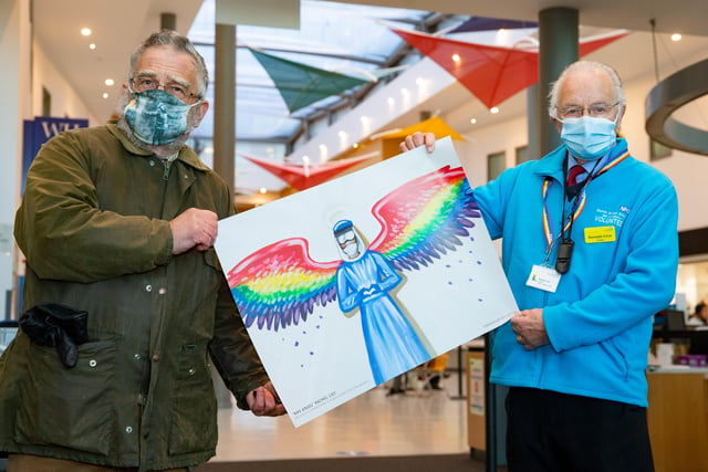 John Brandler donating a PPE angel print to a Peterborough City Hospital staff member. Photo: Rachel List/Bav Media.