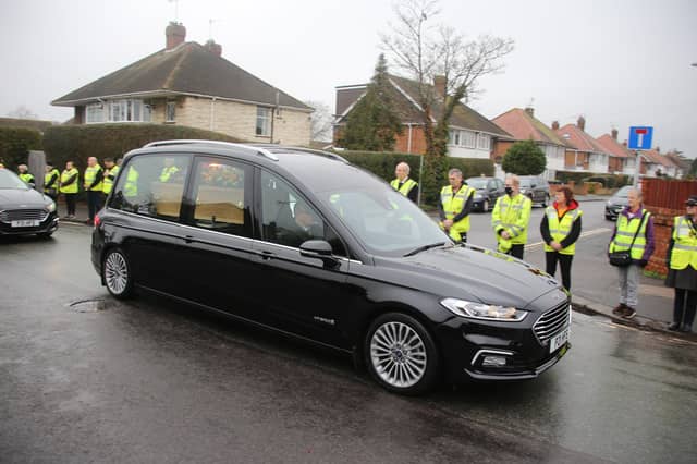 Scores of people lined the street to pay tribute to Worthing lollipop man Terry Rickards as his funeral cortege drove past the spot where he served