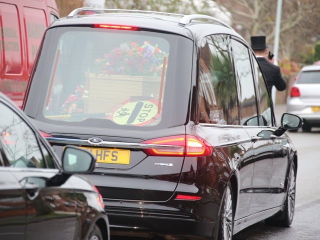 Scores of people lined the street to pay tribute to Worthing lollipop man Terry Rickards as his funeral cortege drove past the spot where he served
