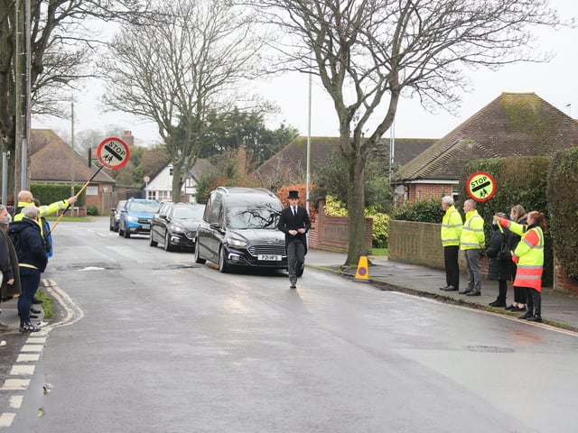 Scores of people lined the street to pay tribute to Worthing lollipop man Terry Rickards as his funeral cortege drove past the spot where he served