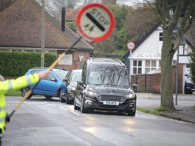 Scores of people lined the street to pay tribute to Worthing lollipop man Terry Rickards as his funeral cortege drove past the spot where he served