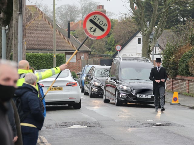 Scores of people lined the street to pay tribute to Worthing lollipop man Terry Rickards as his funeral cortege drove past the spot where he served