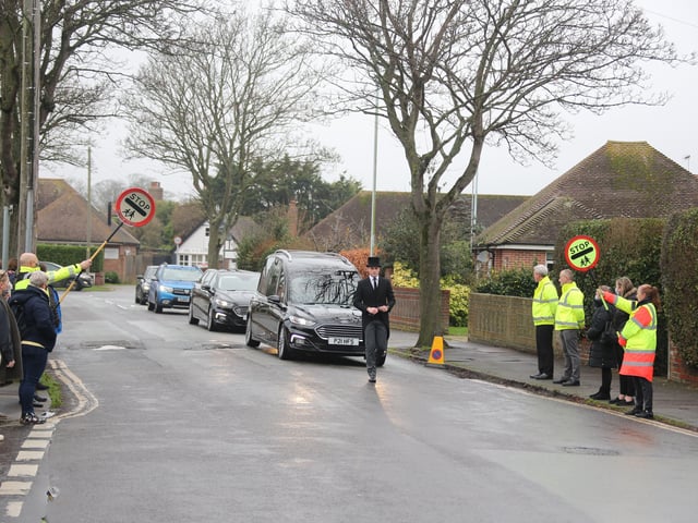 Scores of people lined the street to pay tribute to Worthing lollipop man Terry Rickards as his funeral cortege drove past the spot where he served