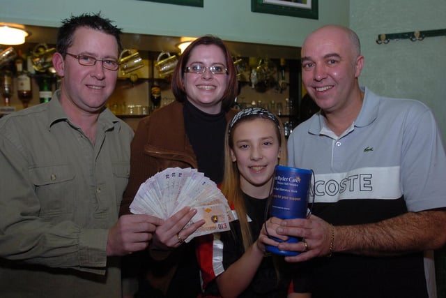 Royal Oak, Lincoln Road landlords  John Devine and Steve Pearce with their  young sponsored kickboxer Emma Wells present cash to sue Ryder care  fundraiser Emma Long following fundraising at their beer and music festival