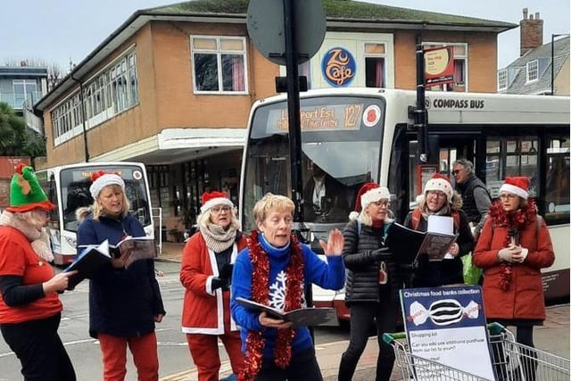 The Paddock Singers entertain shoppers outside Waitrose with cleverly doctored carols about food banks