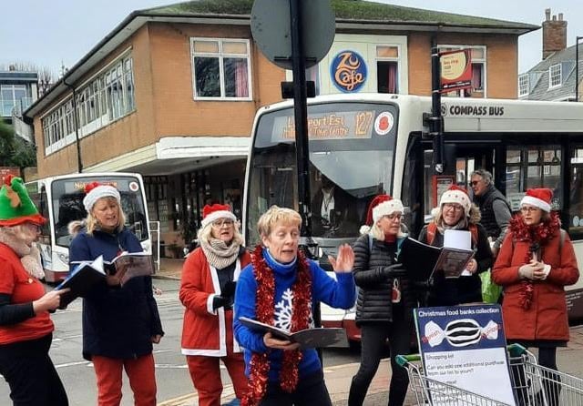 The Paddock Singers entertain shoppers outside Waitrose with cleverly doctored carols about food banks
