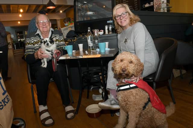 All of those pigs in blankets were heaven for these pooches. Roy Lawson with his dog, Tommy, and Teresa Woodland with her dog, Monty, enjoying the feast.
