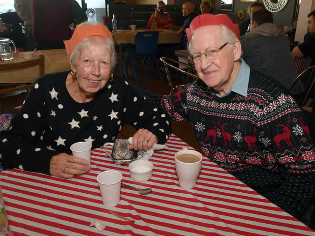 Rocking the Christmas sweaters are Joan and Trevor Scott.
