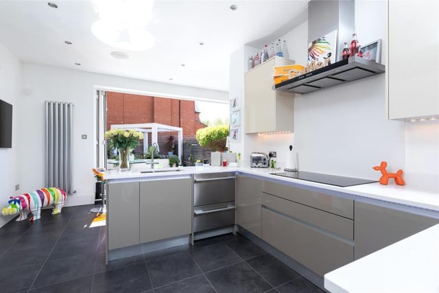 The kitchen/breakfast room has integrated appliances including an electric oven, a combination oven/microwave and a warming drawer. Bi-fold doors connect the room to the garden and there is a door to the garage/utility area