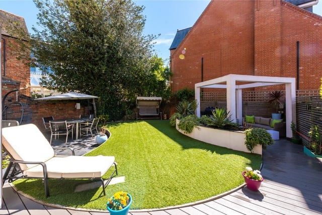 The rear garden has been professionally landscaped and includes a central shaped area with artificial lawn as well as split level composite decked areas and a slate outside dining area.