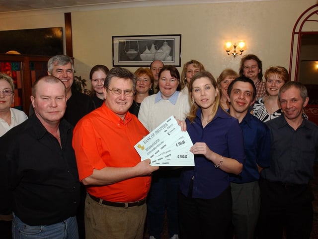 Pictured at the Hospital Club in Thorpe Road are Posties who have raised cash with a panto and have raised 1,100 pounds. Pictured front L-R, are Steven Jones and Leonie Owens from Deaf Blind UK.