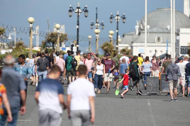 People enjoying Worthing seafront in the sunshine