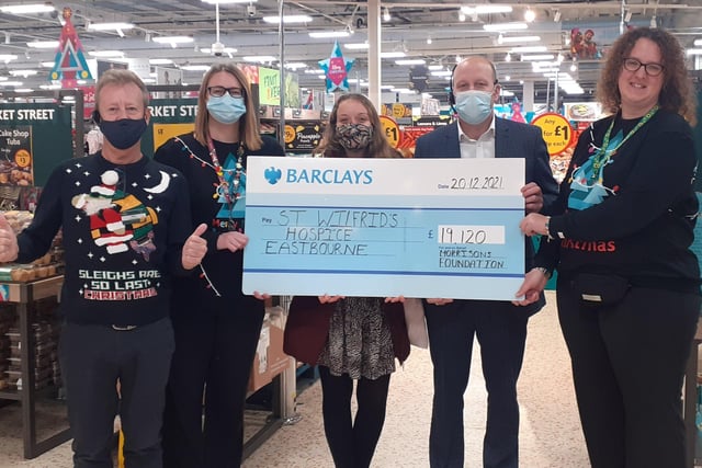 Morrisons Eastbourne community champions with a cheque for St Wilfrid's Hospice SUS-211223-110108001