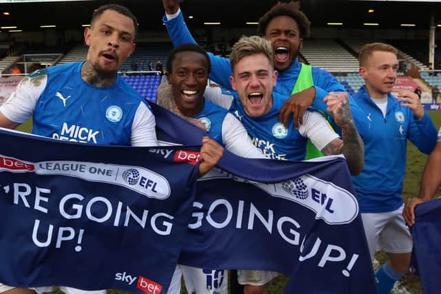 Posh players celebrate promotion from League One in May.