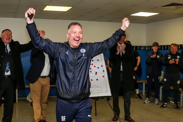 09/05/21 Manager Darren Ferguson leads the Posh promotion celebrations in the changing room following the final game of the season at Doncaster Rovers.