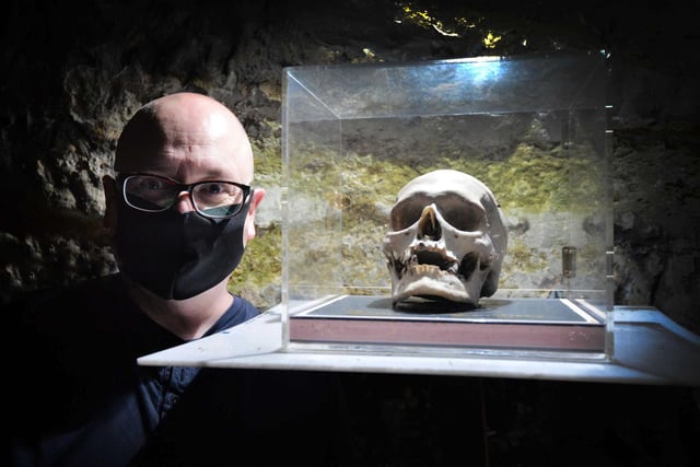 The True Crime Museum getting ready to reopen on May 17. Curator Joel Griggs is pictured with the skull of  Louis Lefevere.