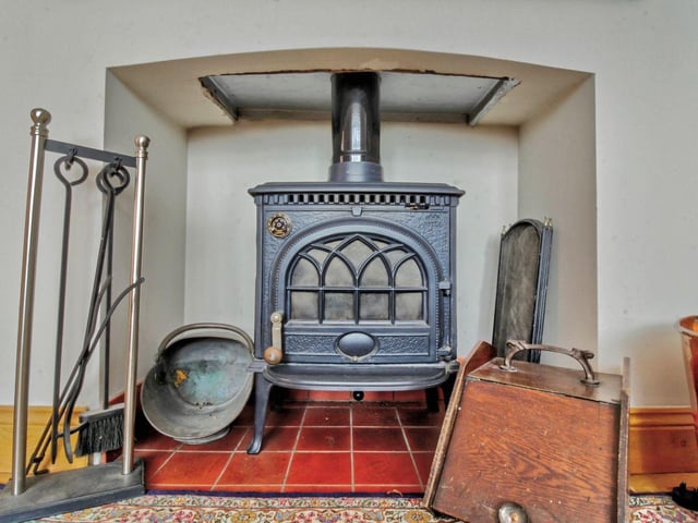The lounge has a large brick built fireplace with a cast iron wood burning stove and offers plenty of space for large sofas and other furniture.