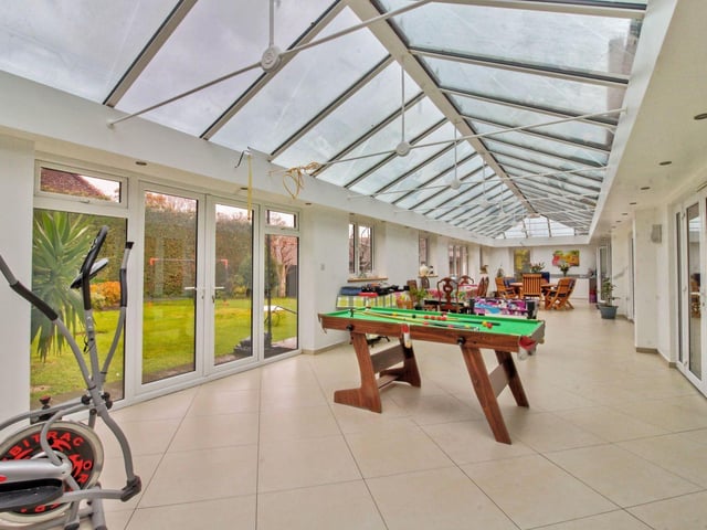 Stretching across the full width of the rear of the property is the huge conservatory which has underfloor heating beneath the tiled floor