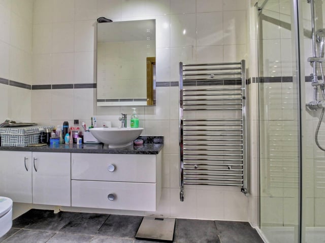 Along the landing are the modern family bathroom and a separate shower room with a large walk-in shower, both fitted to a high standard.