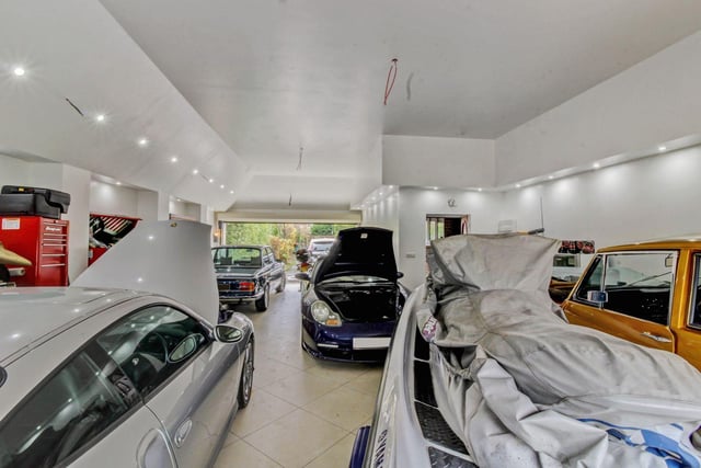 Outside there is an attached garage which is large enough to be a fantastic workshop for any car and/or bike enthusiast, as it comfortably has space for 5-6 vehicles with electric double width doors to both the front and rear.