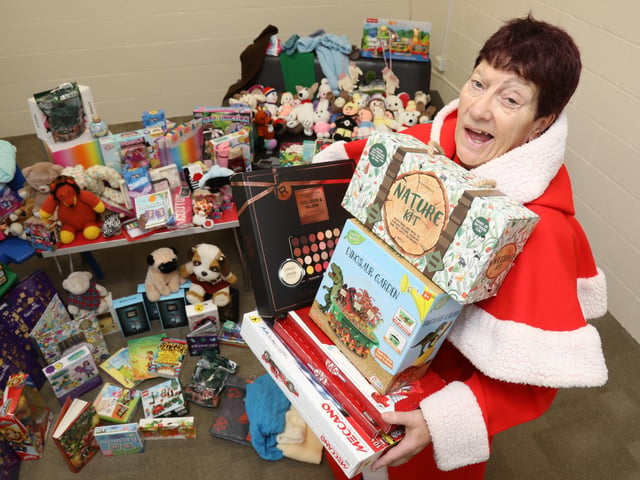 Mother Christmas, retired social worker Jeanette Walsh, with some of the presents donated to the annual gift appeal
