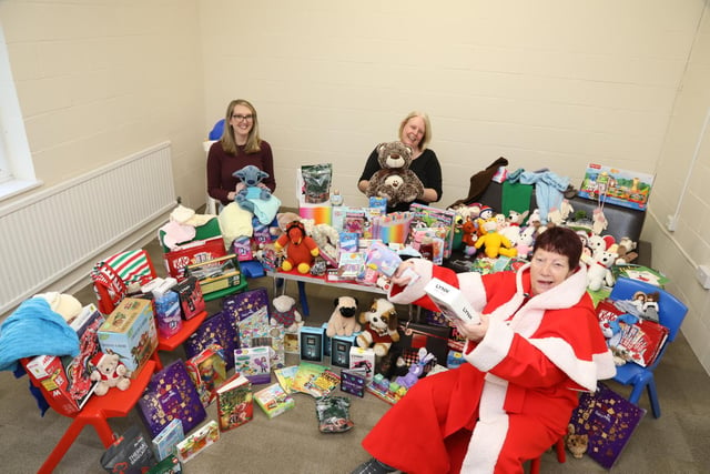 Corby social workers and Jeanette with some of the toys donated to families in the town