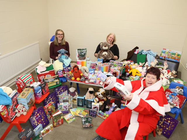 Corby social workers and Jeanette with some of the toys donated to families in the town