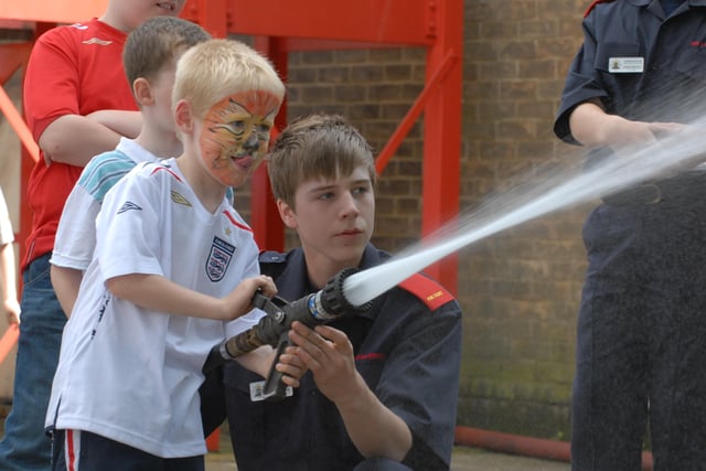 Dogsthorpe fire station open day, Dogsthorpe Road. Jamie Morris (6) takes on target practice with water jets with help from fire cadet Nathan Glover (16).
