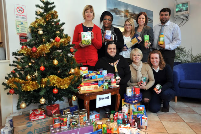 Staff from the DHC Business Centre on Dogsthorpe Road have donated lots of tins to Age UK to help the elderly this Christmas. Back, from left, Collette Davis collecting for Age UK, Barbara Daley, Kayleigh Holmes, Denise Abbondanza, Naushad Lakhani, front, Suki Damani, Alison Grange and Debbie Palmer.