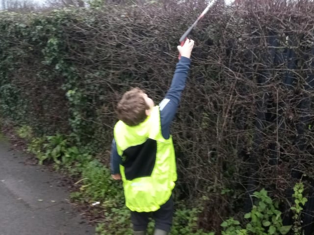 Wombling high, wombling low. Frankie Cairns, 8, gets to work.