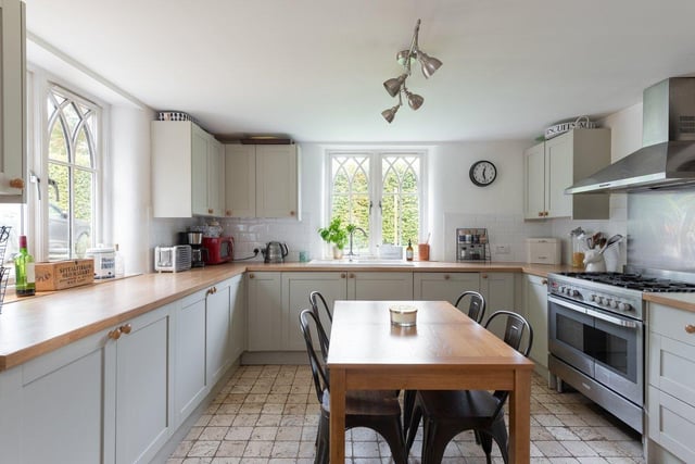 A full range of appliances are hidden in the Shaker-style kitchen