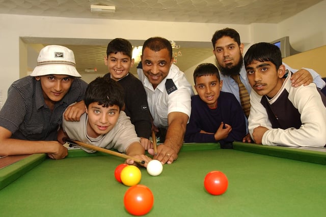 PC Fred Hunte with youngsters and chairman [Sagir Ahmed ] of Planet kids and Youth Connect at Gladstone Street who have received activity equiptment from police fund. We think this picture was taken in 2002.