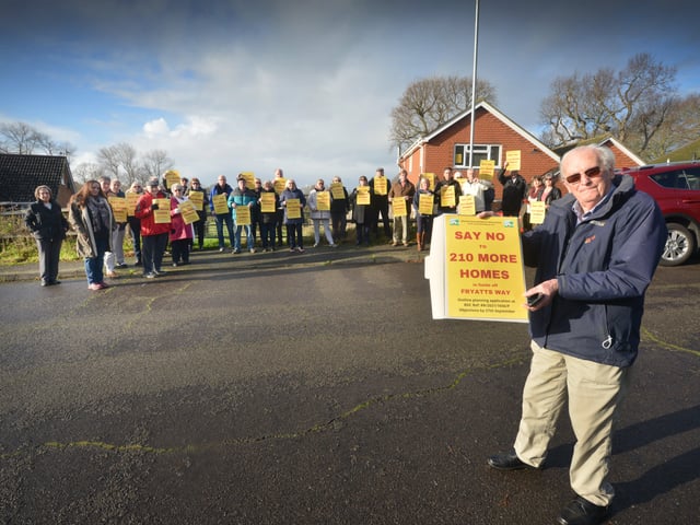 Residents opposed to a planning application to build 210 homes in fields off Fryatts Way in Bexhill.Chris Ashford, Secretary of Ellerslie Area Residents' Association, is pictured with some of the residents in the background. SUS-220401-121512001