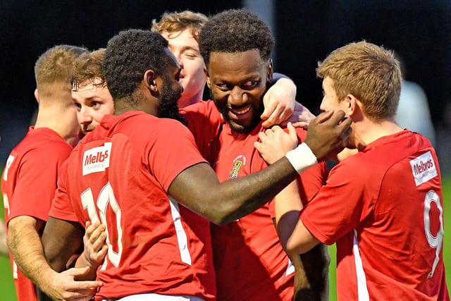 Jamal Clarke is mobbed after heading in Rugby's second goal
